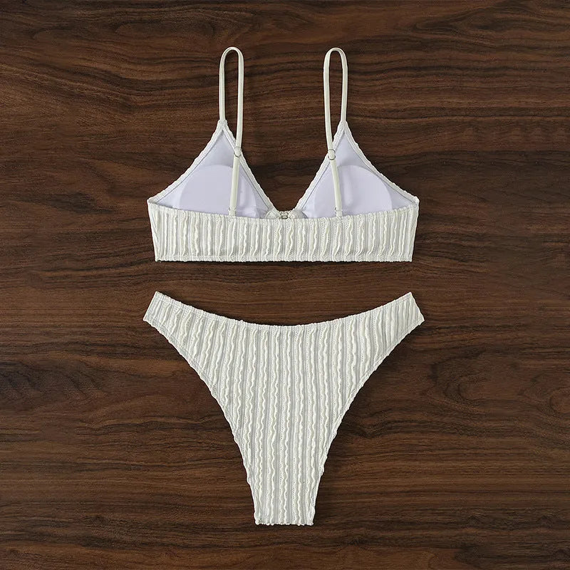 White women's V-neck sleeveless swim top with matching split beach shorts.