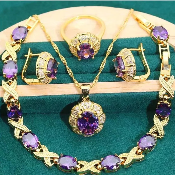 18k gold plated jewellery set with blue cubic zirconia stones showing necklace, earrings, ring, and bracelet