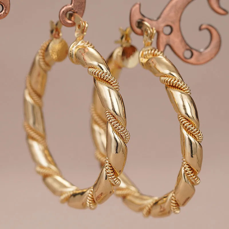 Women's geometric copper ear clips with ring and line elements in golden colour
