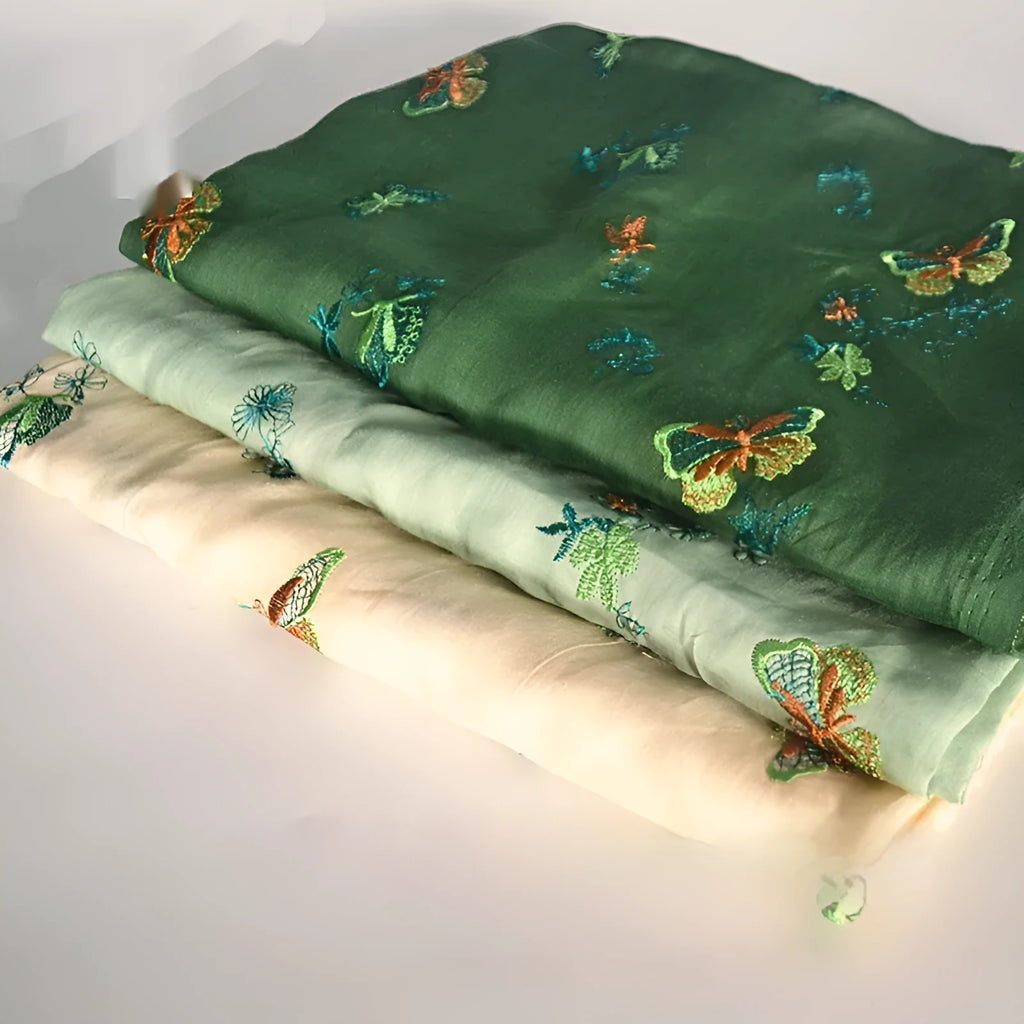Pure ramie fabric for hanfu in beige, grass green, and dark green colours, showing texture.