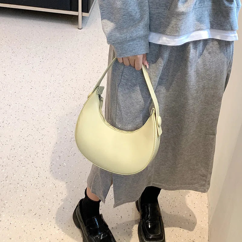 Retro dumpling-shaped women's shoulder bag in PU leather, showing sandwich pocket and cream yellow colour