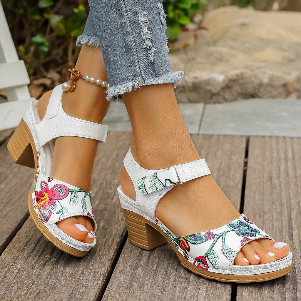 White women's high heel sandals with a velcro strap closure and rubber sole.