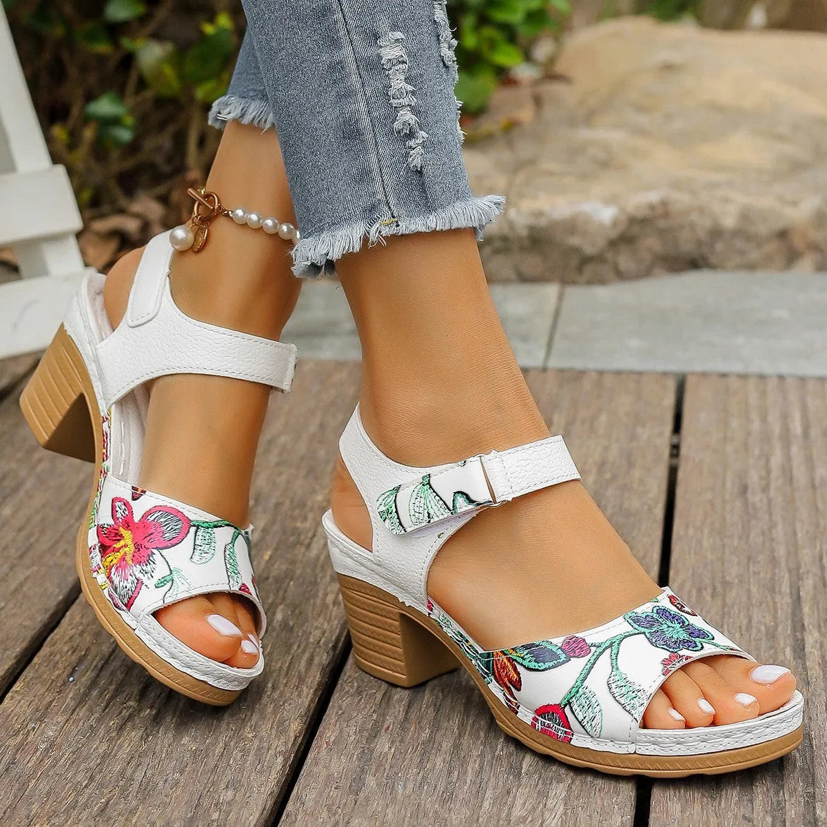 White women's high heel sandals with a velcro strap closure and rubber sole.