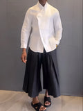 White asymmetric front women's shirt with black pleated trousers casual set