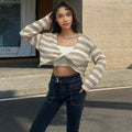 Striped long-sleeved sweater with front and back wearable design and exposed navel detail.