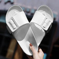 Women's grey-blue EVA flip-flop slippers with a silver buckle fastening on a white background.