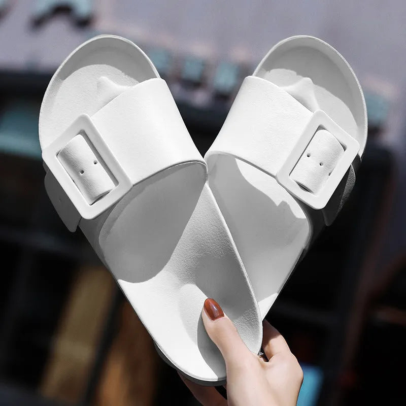 Women's grey-blue EVA flip-flop slippers with a silver buckle fastening on a white background.