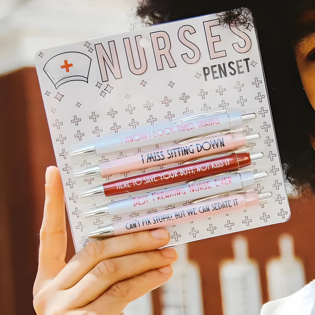 Set of five plastic nurse humour retractable ballpoint pens showing size.