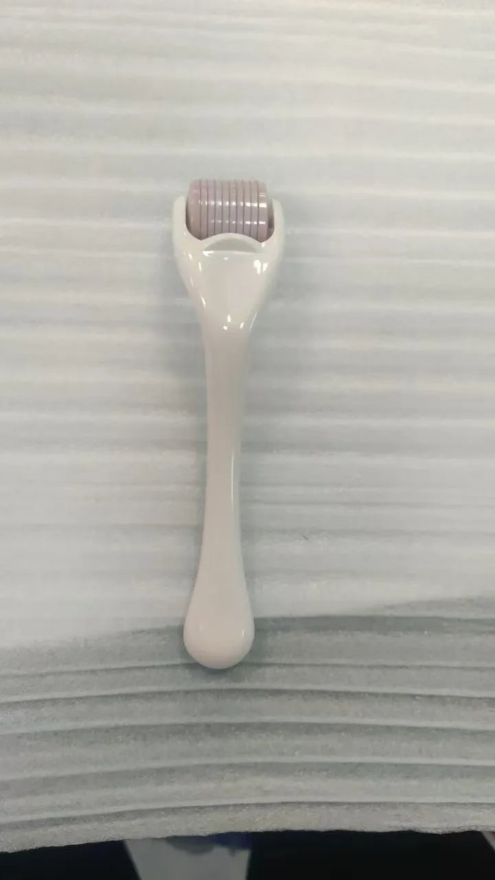 Sterile 540 micro needle derma roller showing handle and needle wheel in assorted colours.