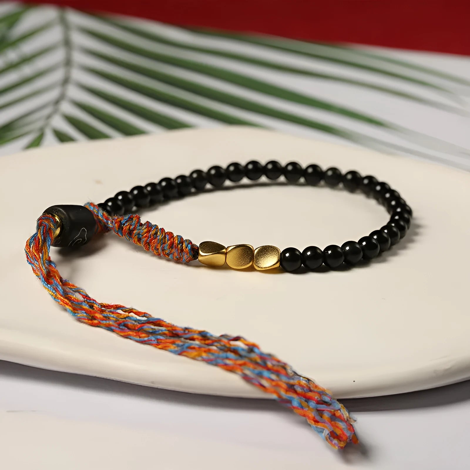Hand-woven obsidian carrying strap showing woven texture and adjustable 15.5-16cm length