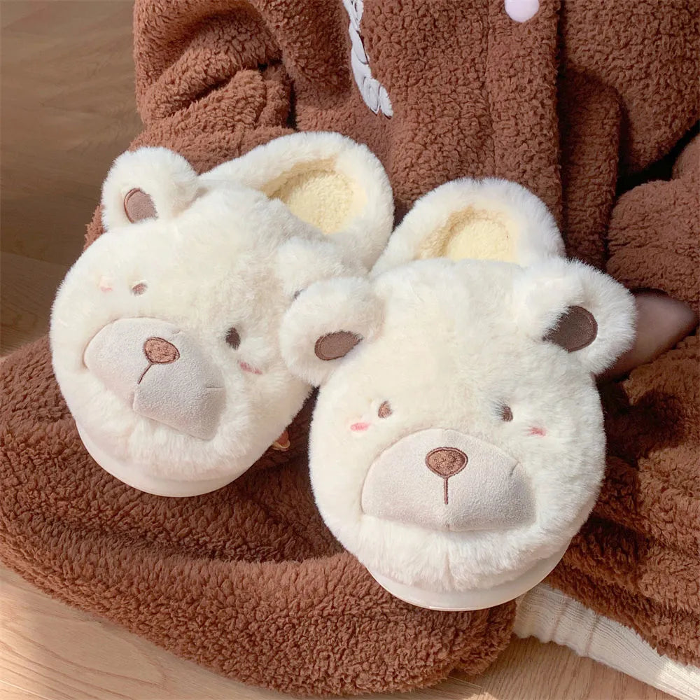 Ladies milky white suede baotou slippers with round toe on a wooden floor.
