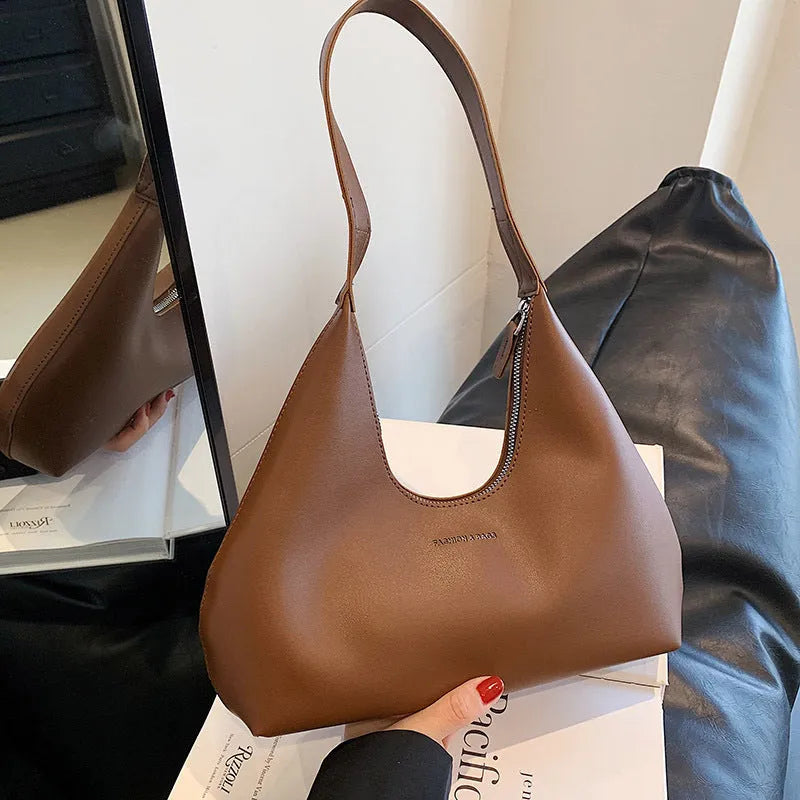 PU leather retro shoulder handbag in pillow design with single strap and internal organisation pockets