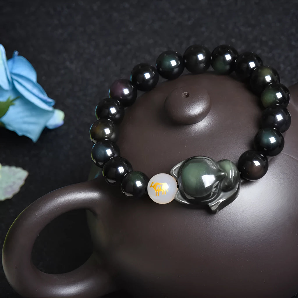 Adjustable obsidian zodiac bracelet with 10mm beads on a wrist.