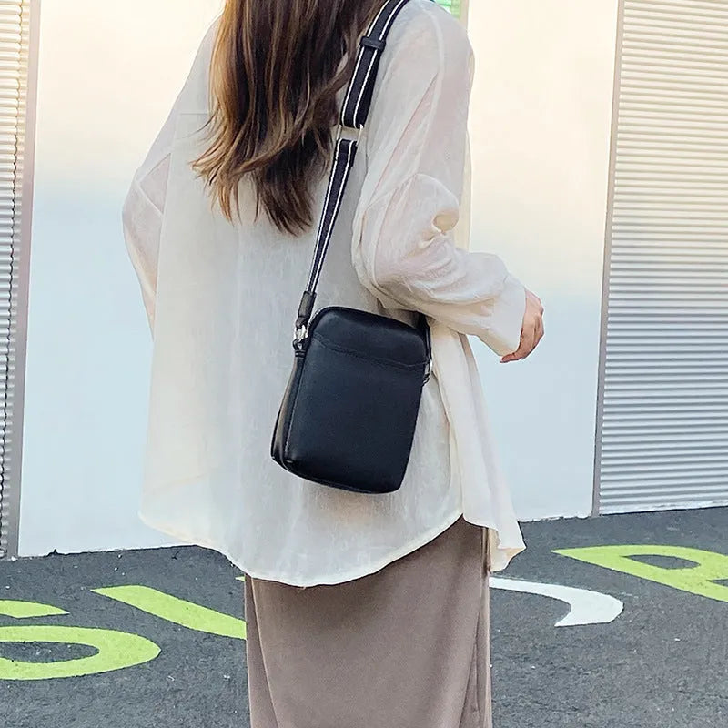 Solid colour PU leather mobile phone crossbody bag in beige showing shoulder strap and compact size