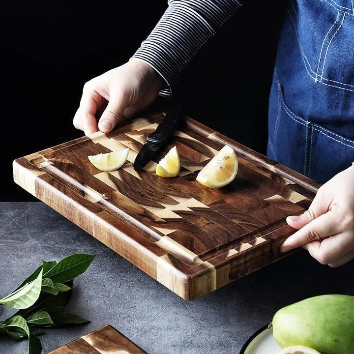 Brown acacia solid wood parquet cutting board with 3cm thickness on a kitchen counter.