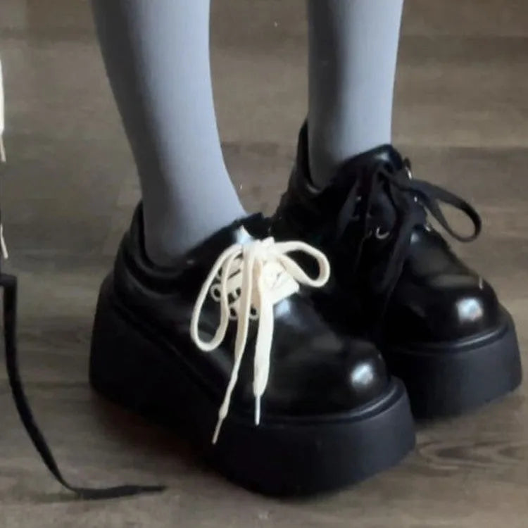Matte black women's lace-up ankle boots with a chunky 6-8 cm heel and thick rubber sole.