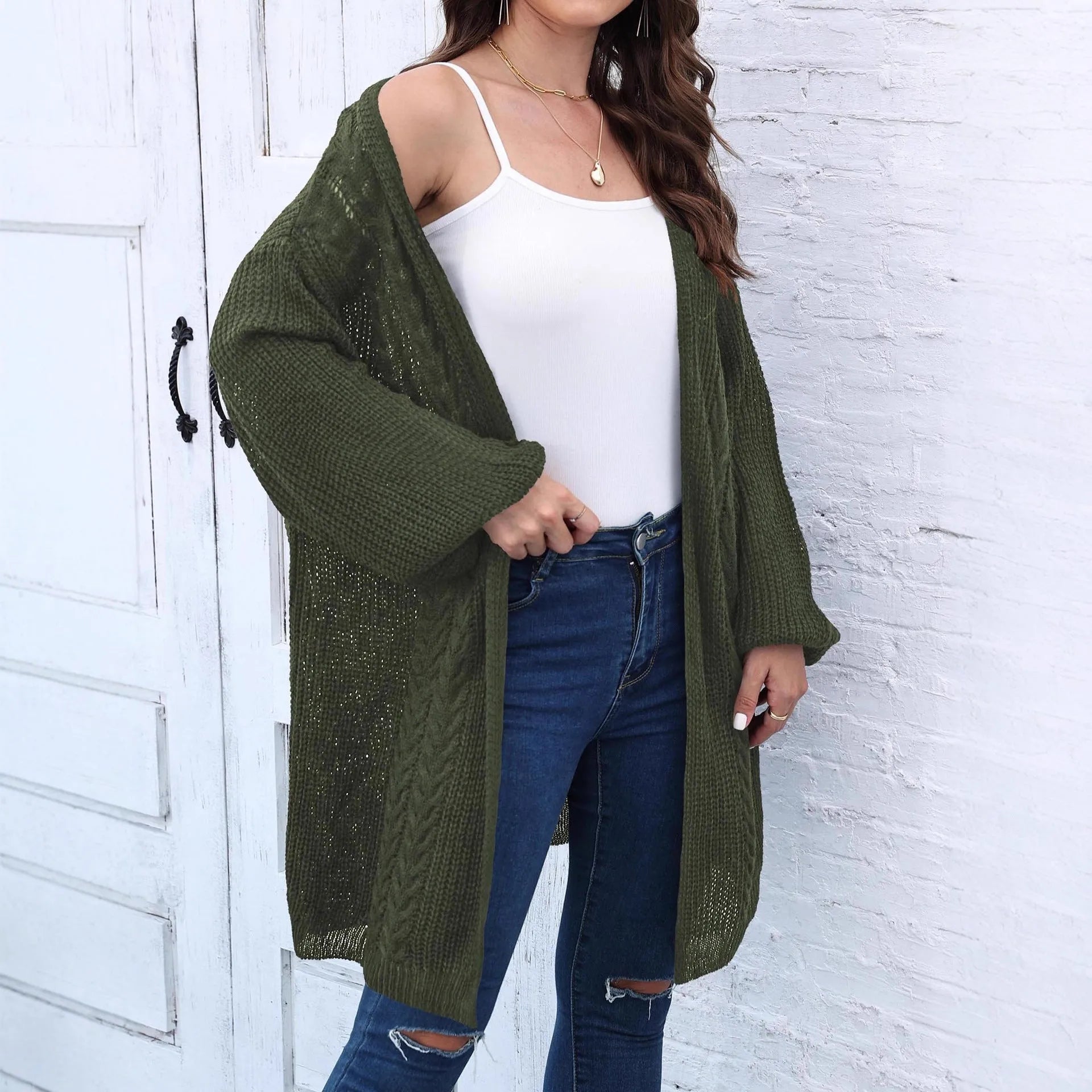 Women's loose fit acrylic sweater coat in a solid colour, shown in a casual setting.