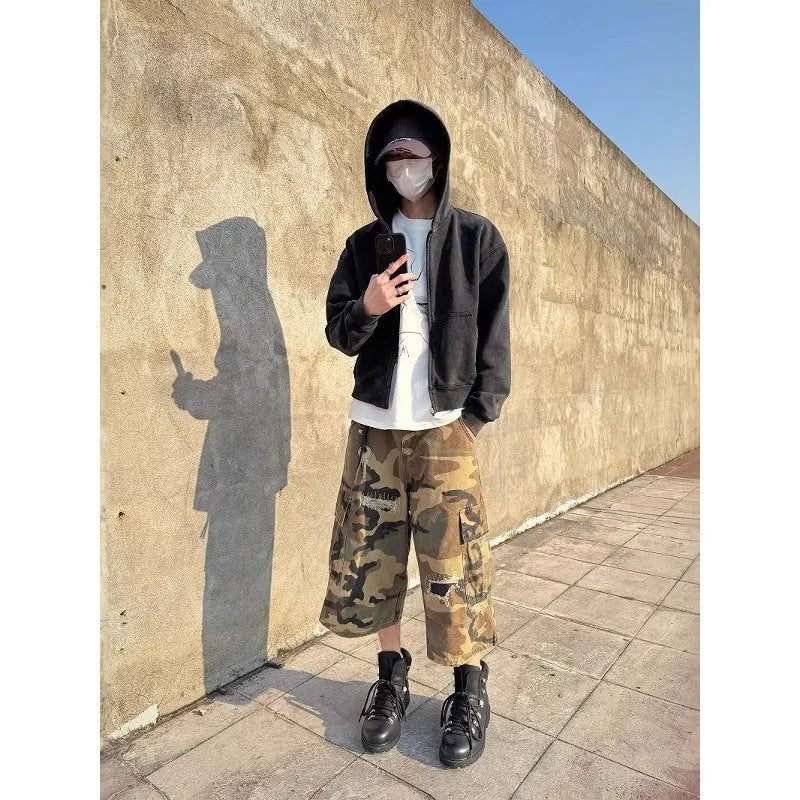Men's camouflage coloured jeans with patchwork and ripped details, cropped length, straight loose fit.