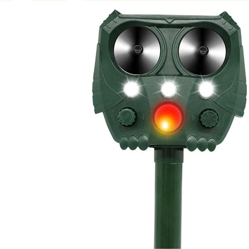 Green solar-powered ultrasonic animal repeller with motion sensor on a white background.