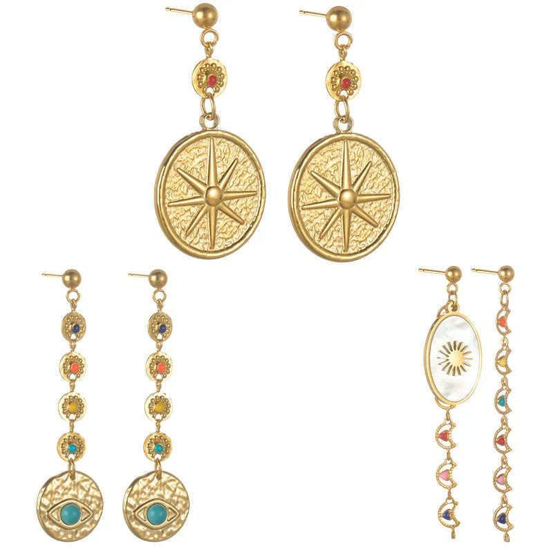 Three pairs of geometric stainless steel drop earrings showing Eight Awn Star, Eye, and Shell Sun designs