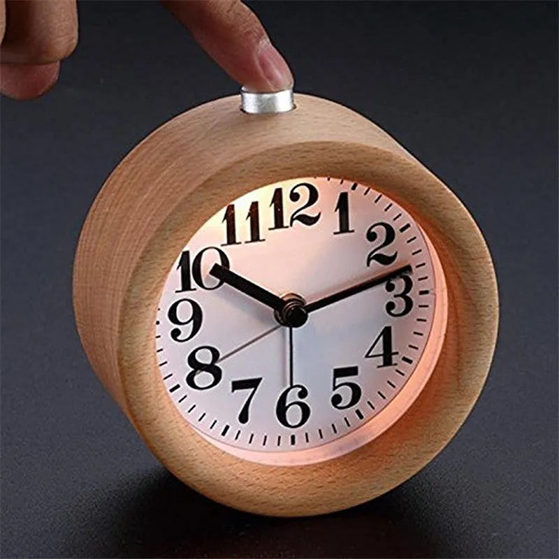 Solid beech wood square alarm clock with traditional analogue dial on wooden surface