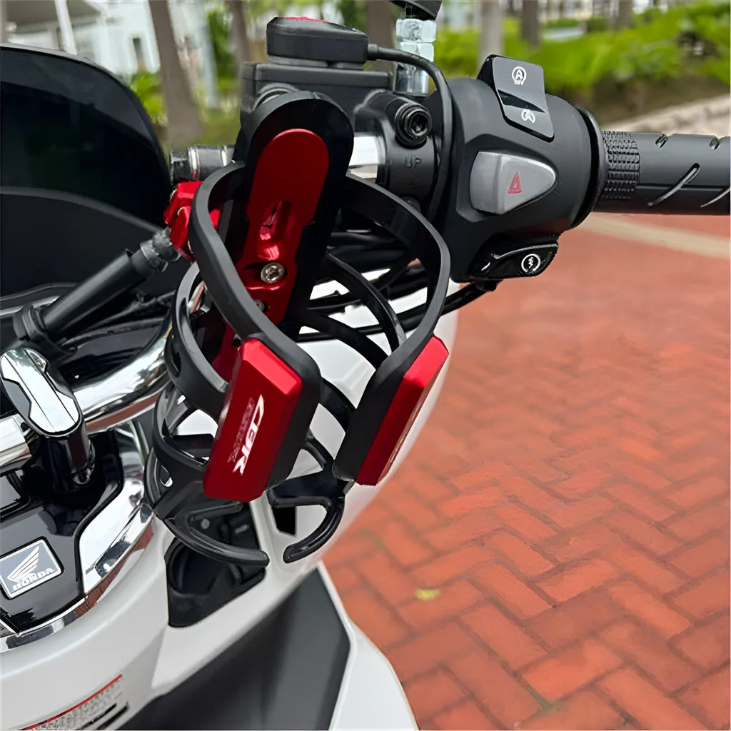Modified black water bottle cage mounted on a Honda X-ADV scooter bumper