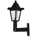 Black hexagonal solar-powered outdoor wall lamp with LED light.