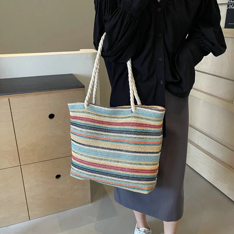 Blue woven nylon shoulder bag with adjustable strap showing straw-like texture pattern