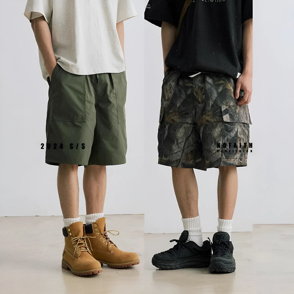 Army green loose fit straight-leg denim shorts with a mid waist and zip fly on a hanger.