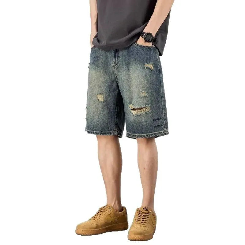 Man wearing blue retro-style loose denim shorts with a straight leg cut.