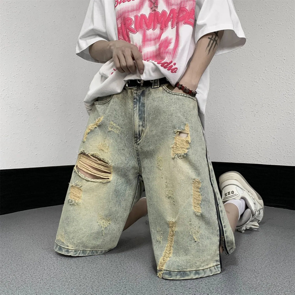 Retro blue men's denim shorts with yellow mud wash and ripped details, loose fit.