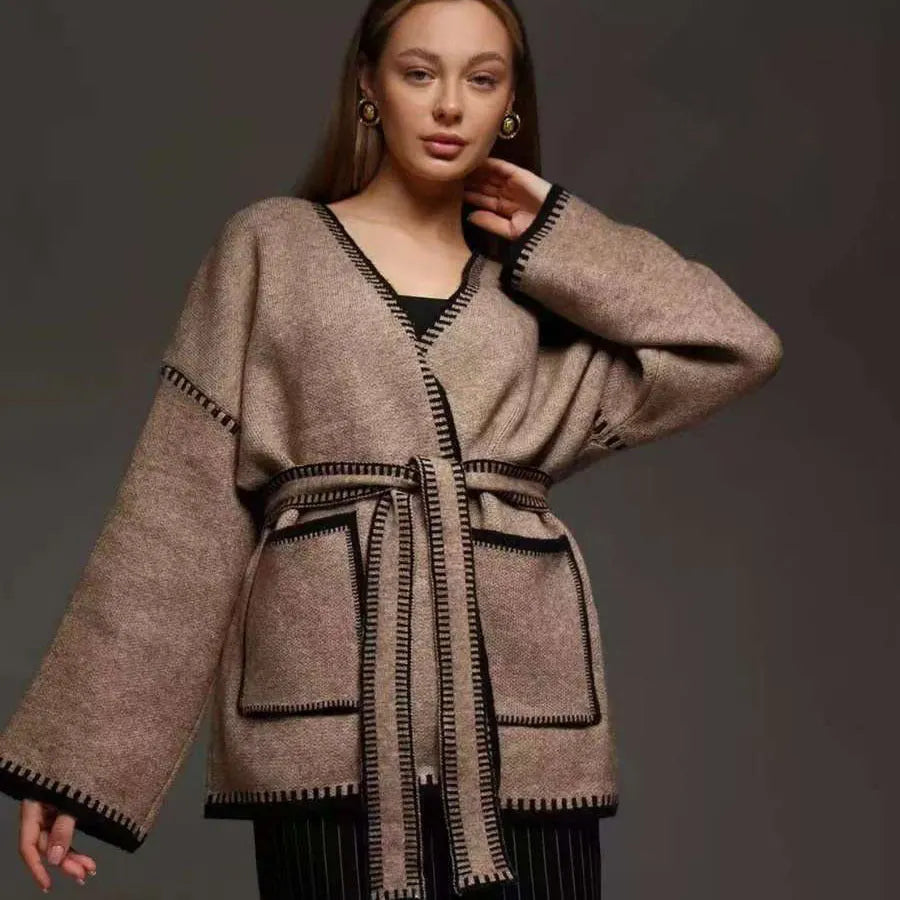 Loose fit knitted cardigan sweater in black, camel, or white colour on a hanger