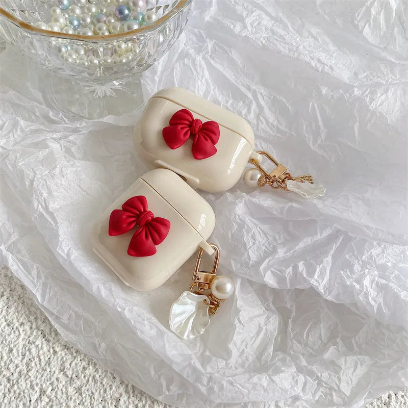 Beige red bow shell TPU AirPods case with clamshell opening design
