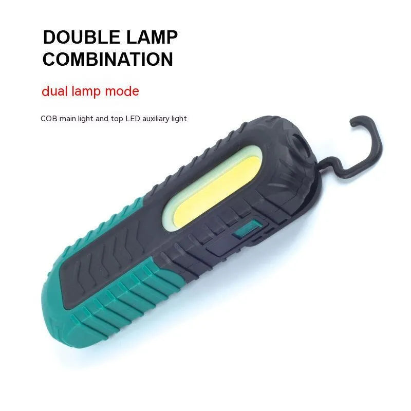 Black and green auto repair work light with USB charging port and drop-resistant coating