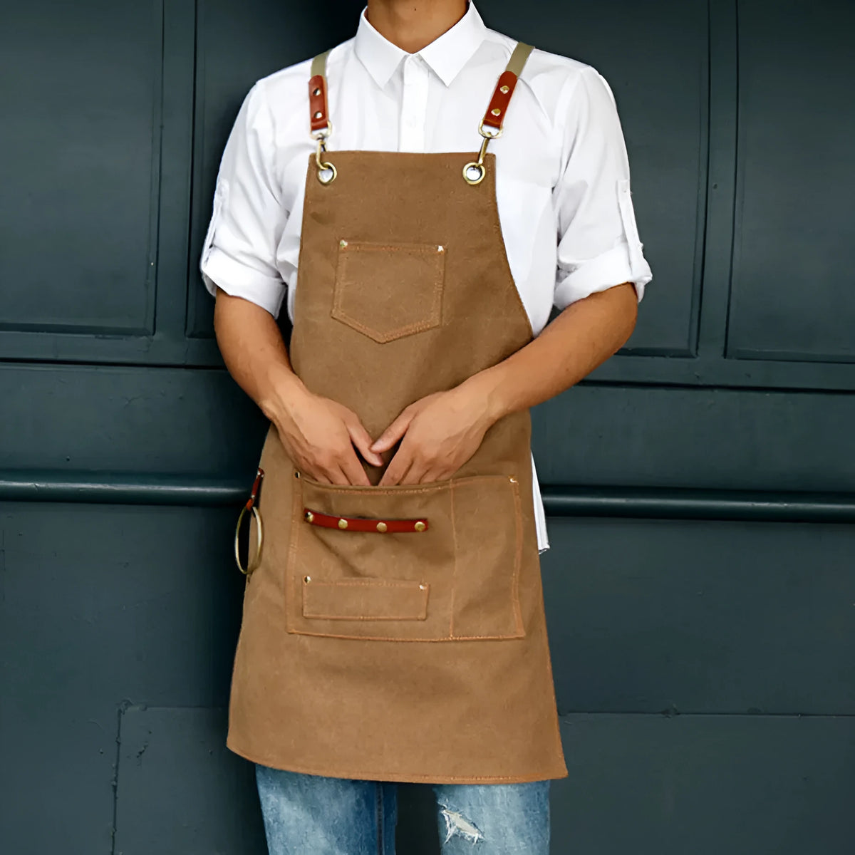 Cross-back canvas apron in camel colour with adjustable straps for café and baking work