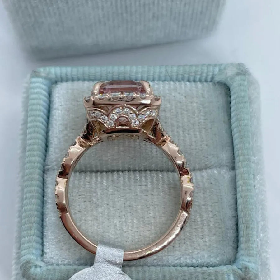Geometric-shaped alloy ring with a rose gold electroplated finish on a neutral background.