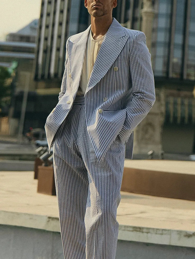 Blue and white striped polyester blazer and trousers suit set on a hanger.