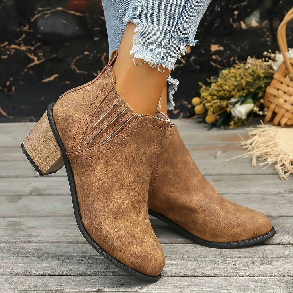 Women's black pointed toe ankle boots with thick square low heel and slip-on design
