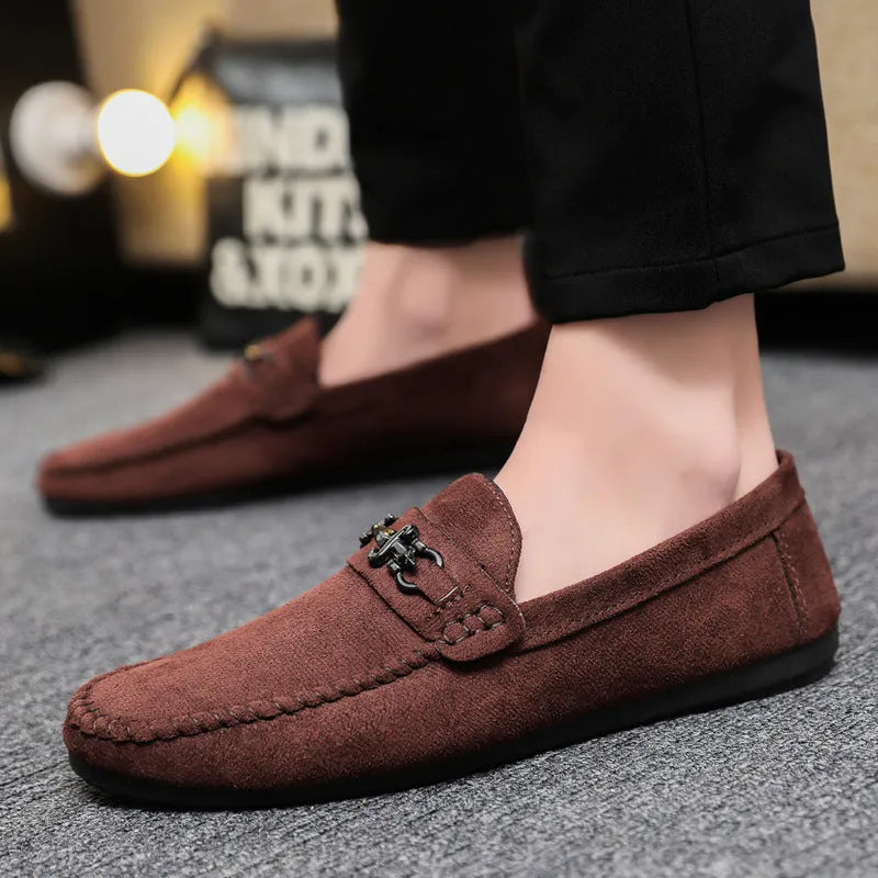 Men's black and brown waterproof slip-on loafers with round toe and low heel on a white background.