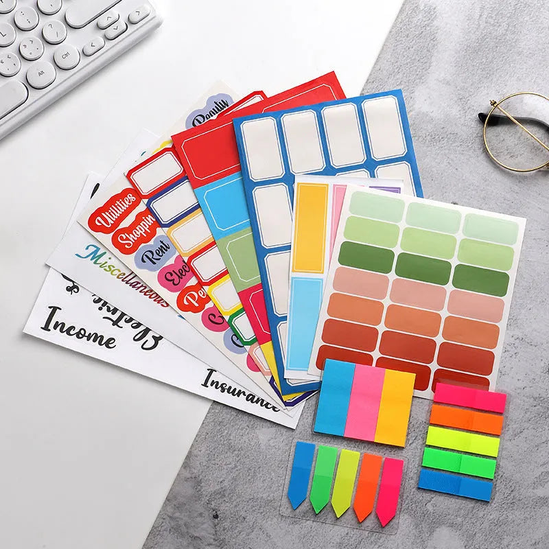 Assorted paper adhesive stickers including grid sheets, colourful sticky notes, and A6 ruler on a surface.