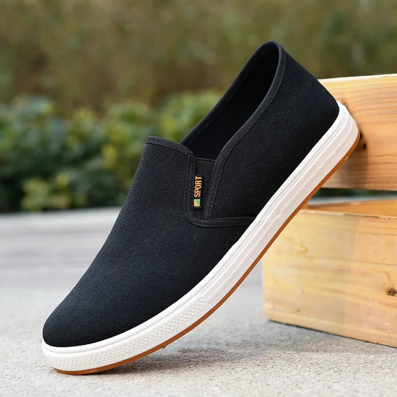 Men's black and blue canvas slip-on shoes with round toe and low-top design on composite sole