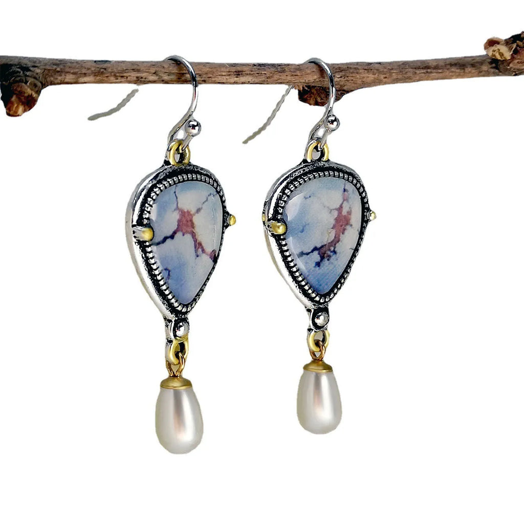 Retro blue drop earrings with synthetic blue opal and white pearl on electroplated metal.
