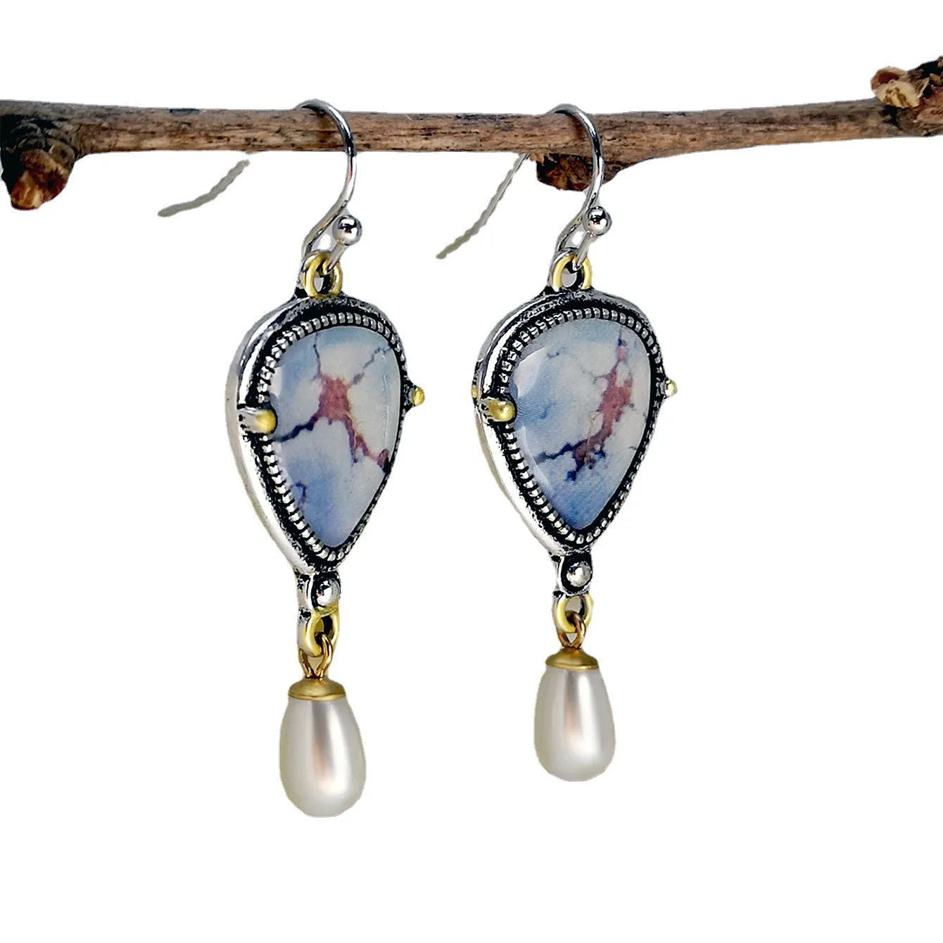 Retro blue drop earrings with synthetic blue opal and white pearl on electroplated metal.