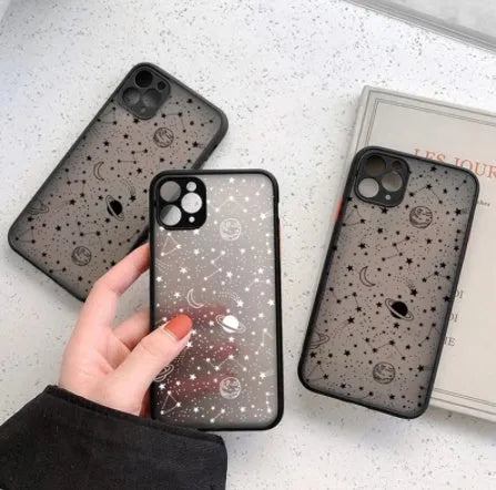Star universe patterned black iPhone case on a mobile phone, showing raised edges around the screen and camera.