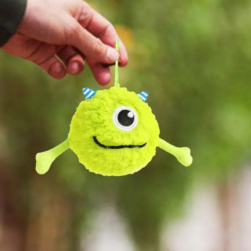 Green plush and TPR dog toy ball with bite-activated sound for teething puppies