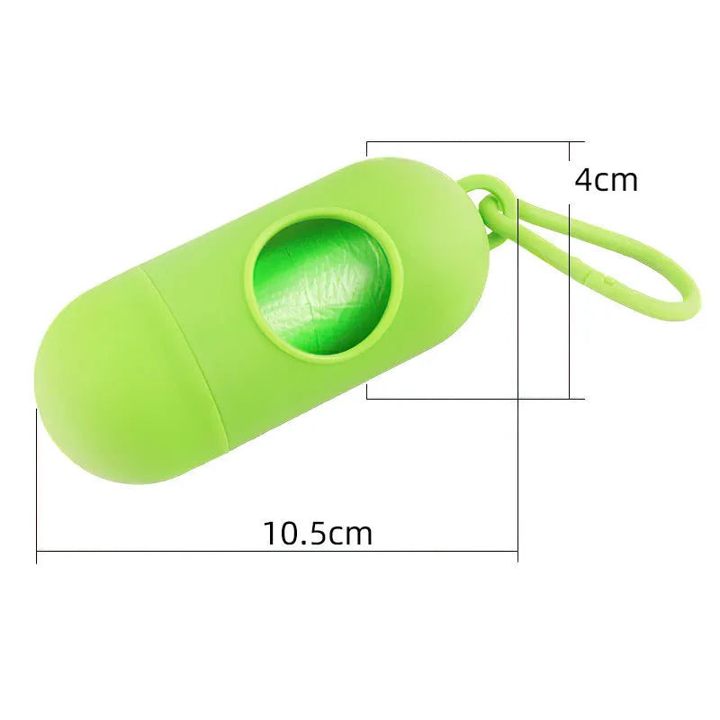 Small black dog waste bag holder with a side clip and Velcro strap, shown next to a roll of poop bags.