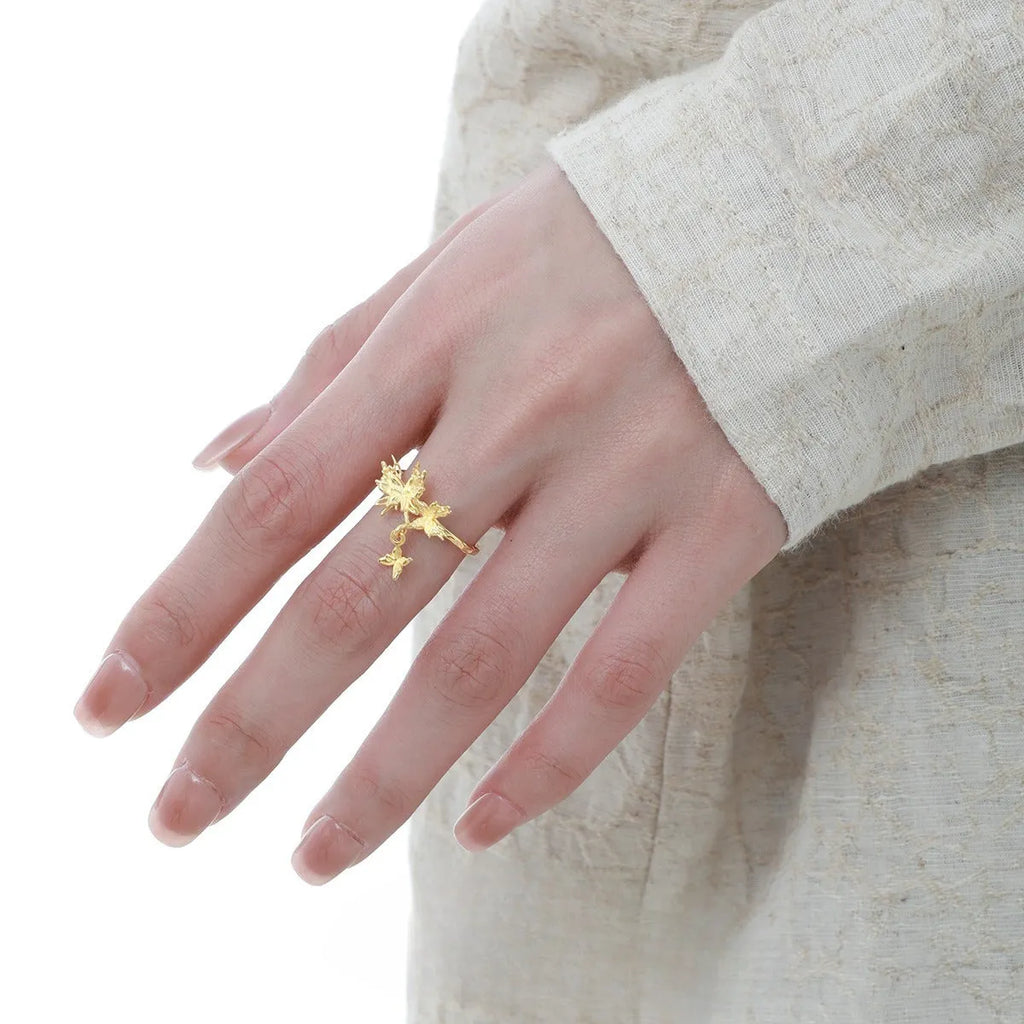 Adjustable silver butterfly ring with gold electroplating on model's finger