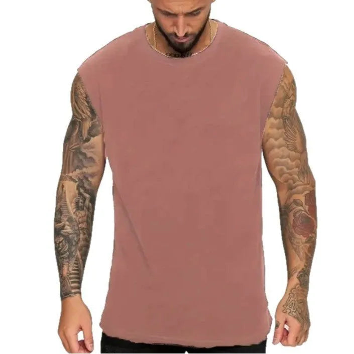 Men's loose fit solid colour cotton sleeveless t-shirt on a hanger, shown in apricot.