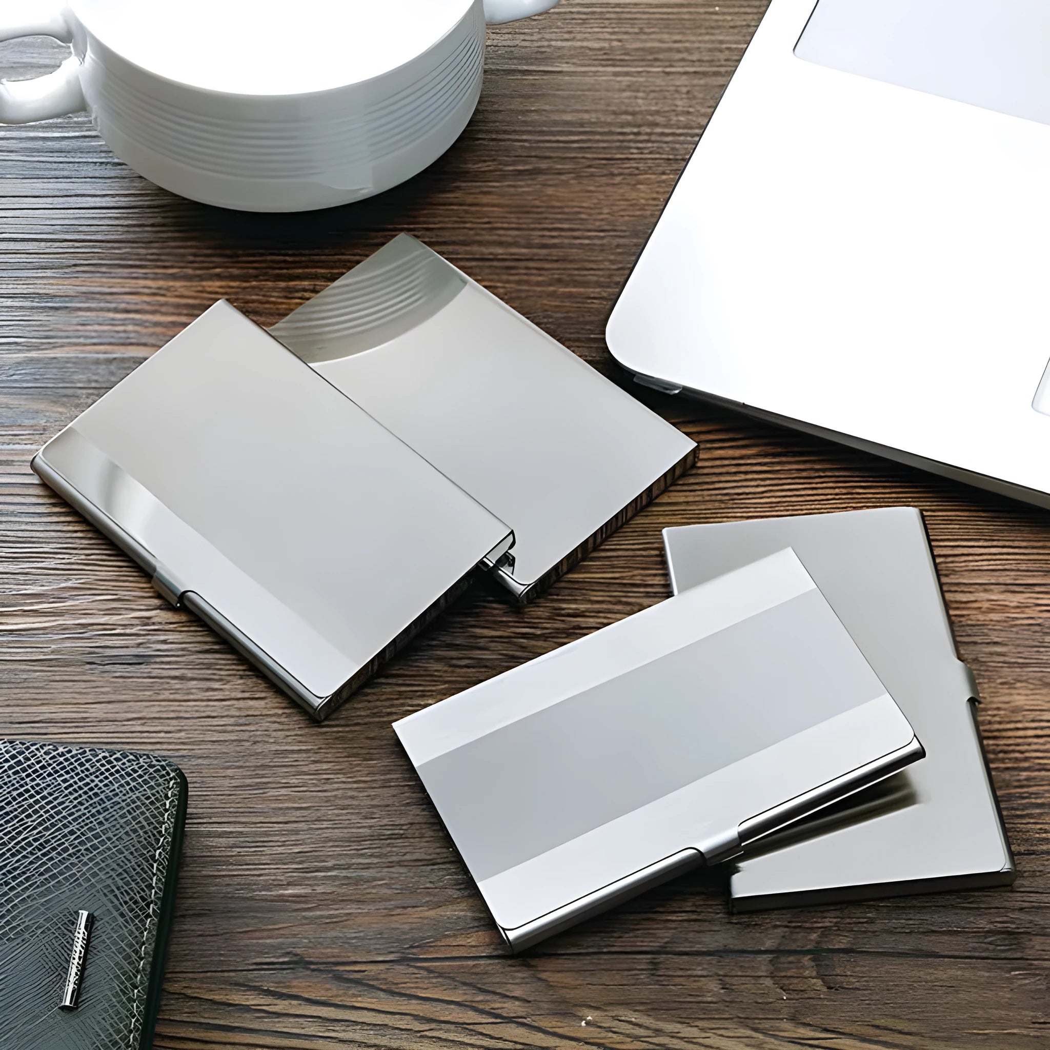 Geometric stainless steel business card case with brushed and mirrored finishes.