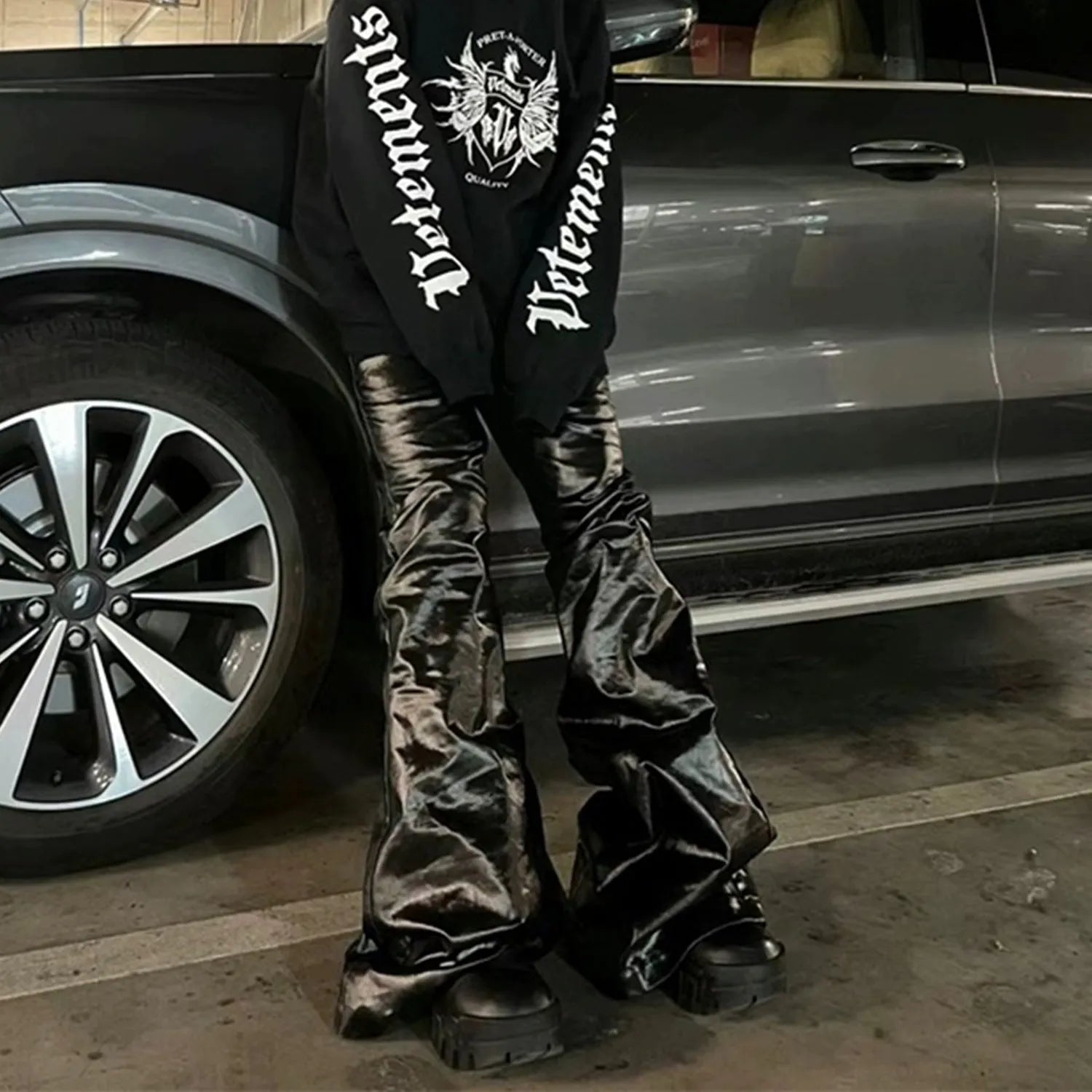 Black coated patent leather straight-leg skinny jeans on a model